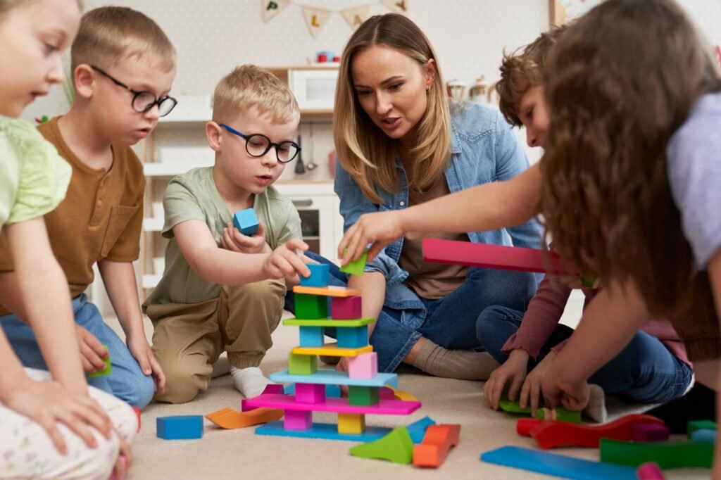 Children playing with toy blocks in the kindergarten Children playing with toy blocks in the kindergarten