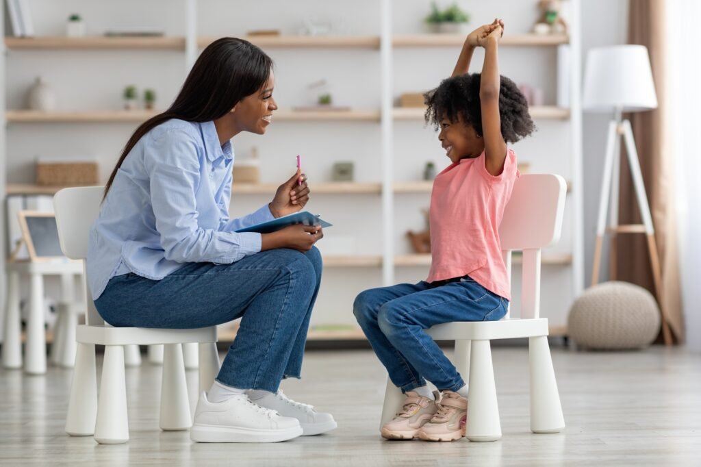 Excited cute little black girl at child psychologists office Excited cute little black girl at child psychologists office