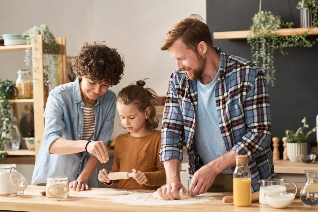 Parents teaching child to bake pie Parents teaching child to bake pie