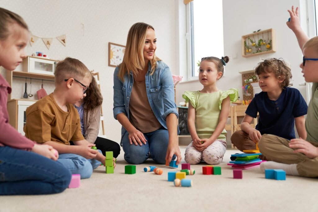 Teacher performs exercises to the children Teacher performs exercises to the children